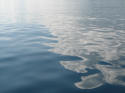 Cloud reflections on calm water