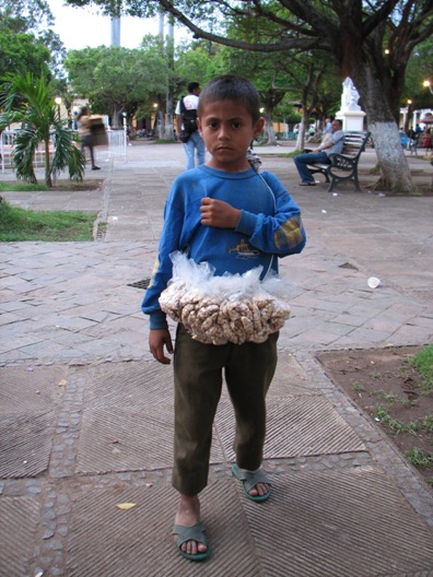 kid selling peanuts on the square. Granada, Nicaragua