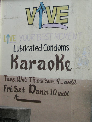 Hand Painted Sign. Condoms Karaoke. Dangriga Town, Belize
