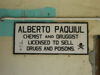 Hand Painted Sign. Alberto Paquiul Chemist and druggist liscensed to sell drugs and poisons. Dangriga Town, Belize
